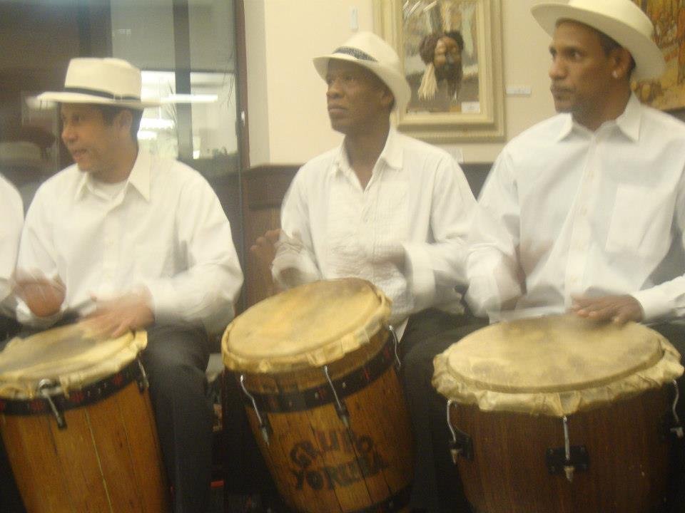 Three drummers playing barrel drums, barriles de bomba