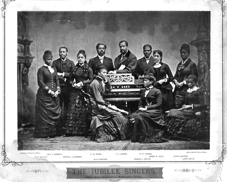 The Fisk Jubilee Singers in 1882: nine singers posed in a studio, two women seated in front